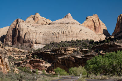 Panoramic view of rocky mountains against clear sky