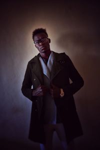 Young man standing against wall