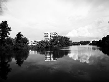 Scenic view of lake by building against sky