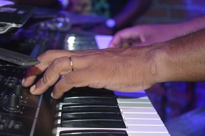 Close-up of man playing piano