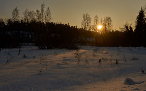 Scenic view of snow field against sky during sunset