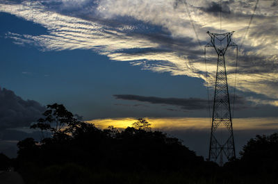 Silhouette trees on landscape against sky