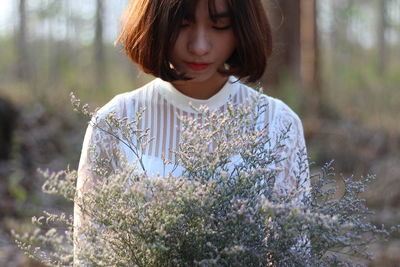 Close-up of girl looking down while standing outdoors