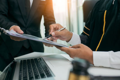 Midsection of man using mobile phone