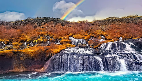 Asadalur village and beautiful waterfall, at rainbow, vagar, faroe islands, denmark.