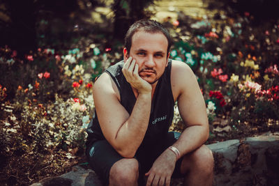 Portrait of young man sitting outdoors