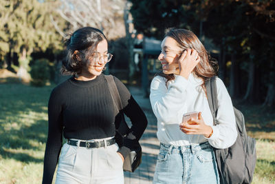 Smiling female friends at park