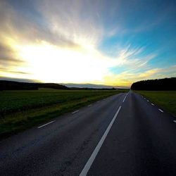 Country road passing through field