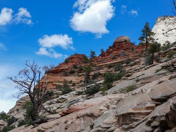 Low angle view of rocks on mountain against sky