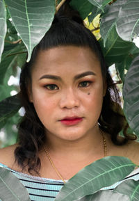 Portrait of woman with leaves outdoors