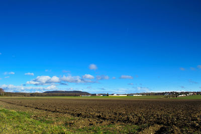 Scenic view of field against blue sky