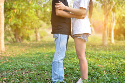 Midsection of woman standing on field