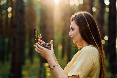 Childhood trauma in adults. outdoor portrait of woman holding a music box in her hands