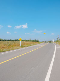 Road sign against blue sky