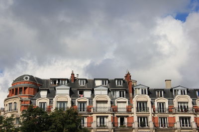 Residential buildings in city against sky