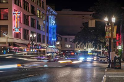 Cars on city street at night