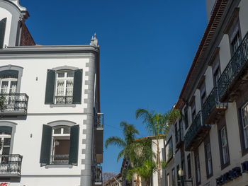 Low angle view of buildings against blue sky