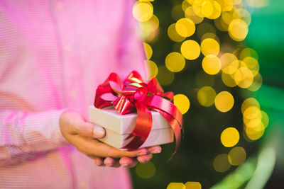 Close-up of hand holding christmas decoration in box