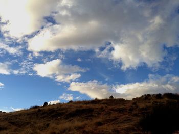 Scenic view of landscape against cloudy sky