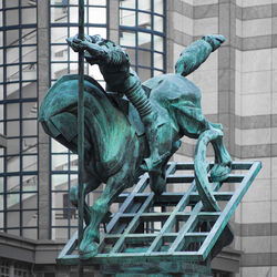 Statue against built structure