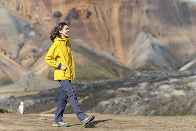 Young woman is admiring iceland's foreign volcanic landscape