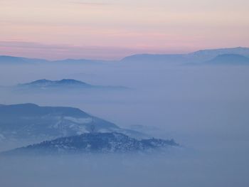 Scenic view of mountains against sky during sunset