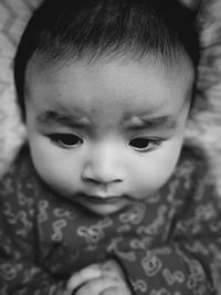 Close-up of cute baby girl sleeping on bed