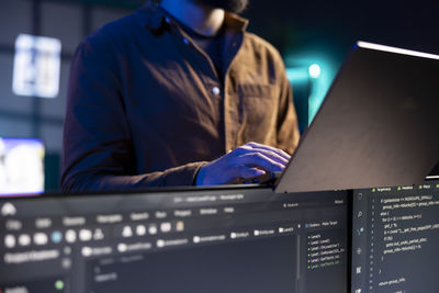 Midsection of man using laptop