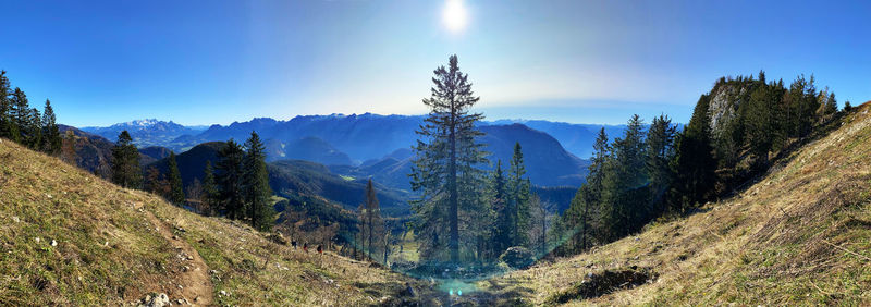 Panoramic view of landscape and mountains against blue sky