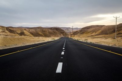 Empty road along countryside landscape