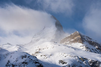 Scenic view of snow covered mountains against sky