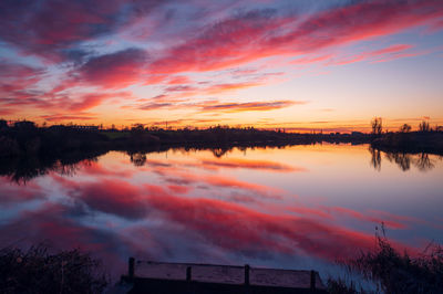 Scenic view of lake against romantic sky at sunset