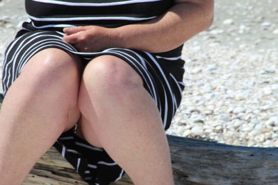 Low section of woman sitting on seat