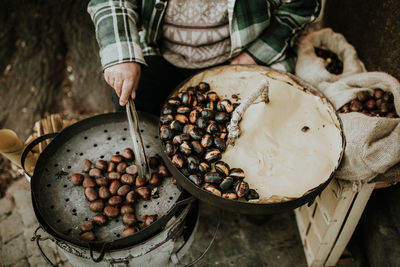 Close-up of person roasting chestnuts