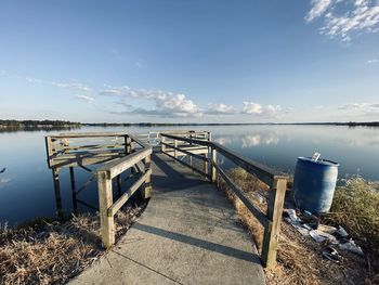 Pier over lake against blue sky