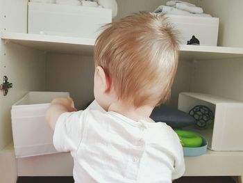 Rear view of man sitting on table