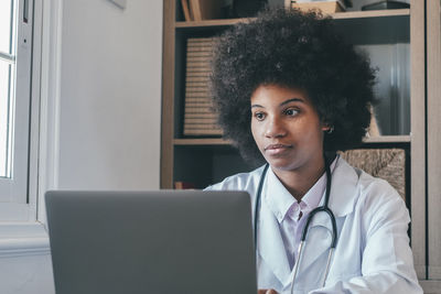 Doctor using laptop in clinic