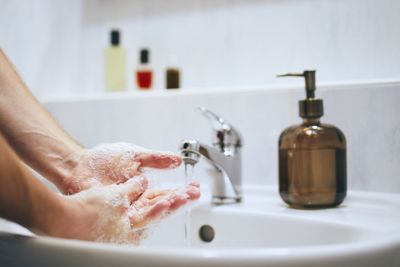 Midsection of woman in bathroom at home