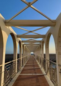 Bridge over sea against clear sky