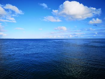 Scenic view of sea against blue sky