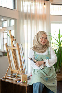 Portrait of young woman reading book