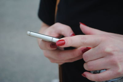 Midsection of woman using mobile phone