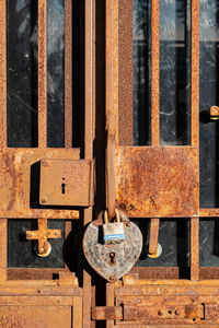 Close-up of padlock on rusty door