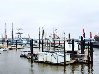 Sailboats moored in harbor