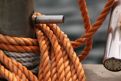 Close-up of rope tied on metal in boat
