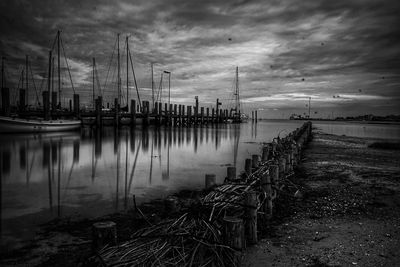View of harbor against cloudy sky