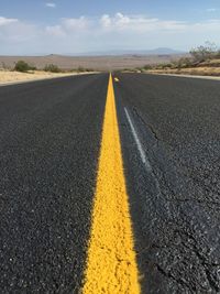 Road amidst landscape against sky