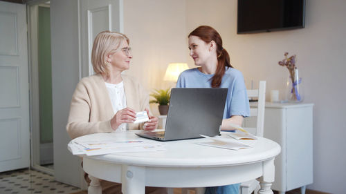 Businesswoman using laptop at home