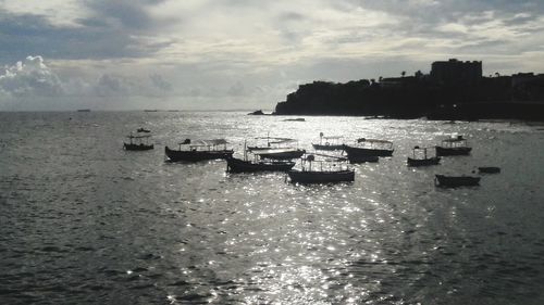 Boats in sea against sky