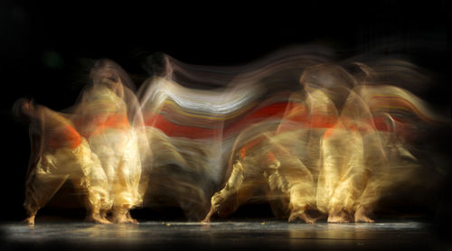 Blurred motion of people dancing at night